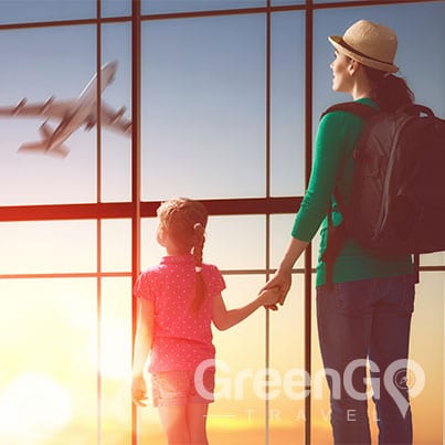 galapagos-cruises-for-families - Woman holding childs hand as they watch plane takeoff