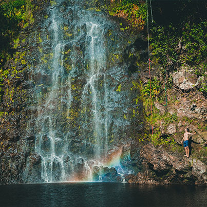 Man standing by Waterfall